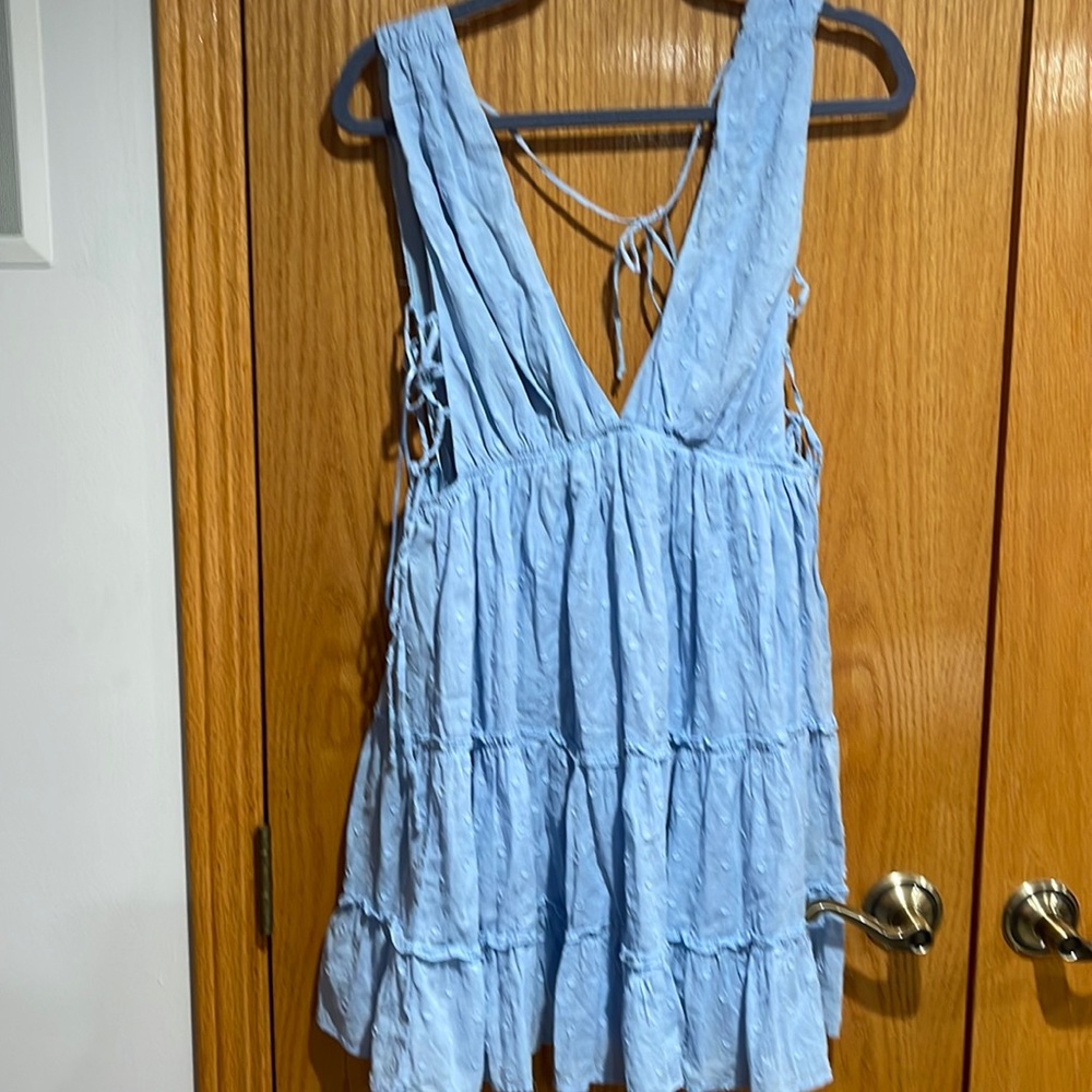 Light blue open v in front and back.. side openings with ties size large